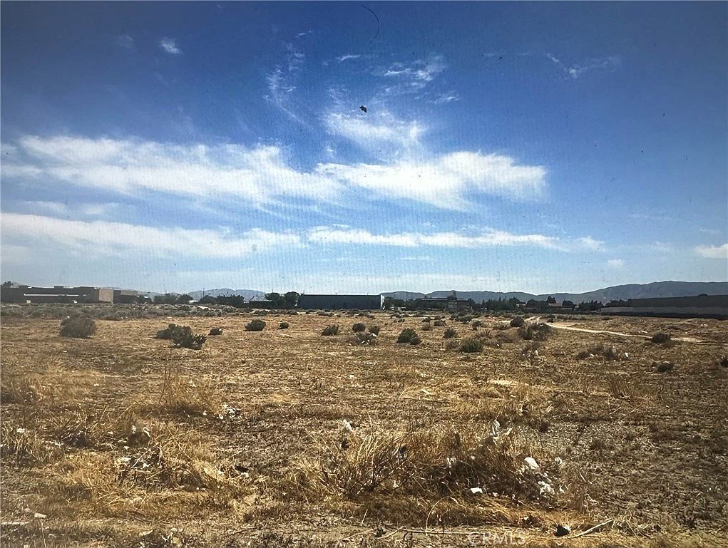 The flat run of seven acres at Avenue J-8 in Lancaster, showing the open ground, accessible topography, and corridor surrounding the parcel